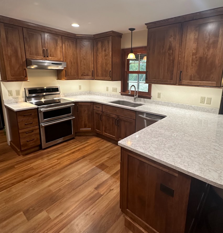 Kitchen remodel showing new medium-dark cabinets and a quartz countertop