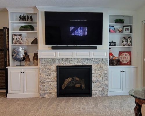 Built in shelves on either side of fireplace.