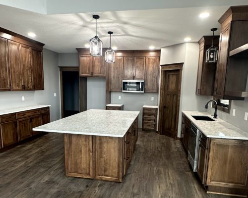 Kitchen remodel showing entire kitchen space with new cabinets, quartz countertops and some floating cabinets.